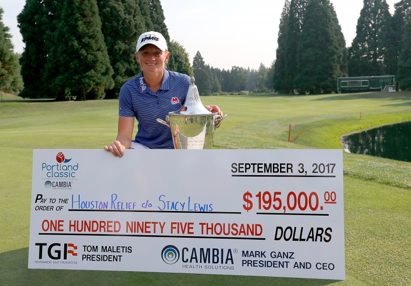 Stacy Lewis with the winners trophy and a donation check