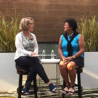 gail baker and nancy lopez speaking on stage