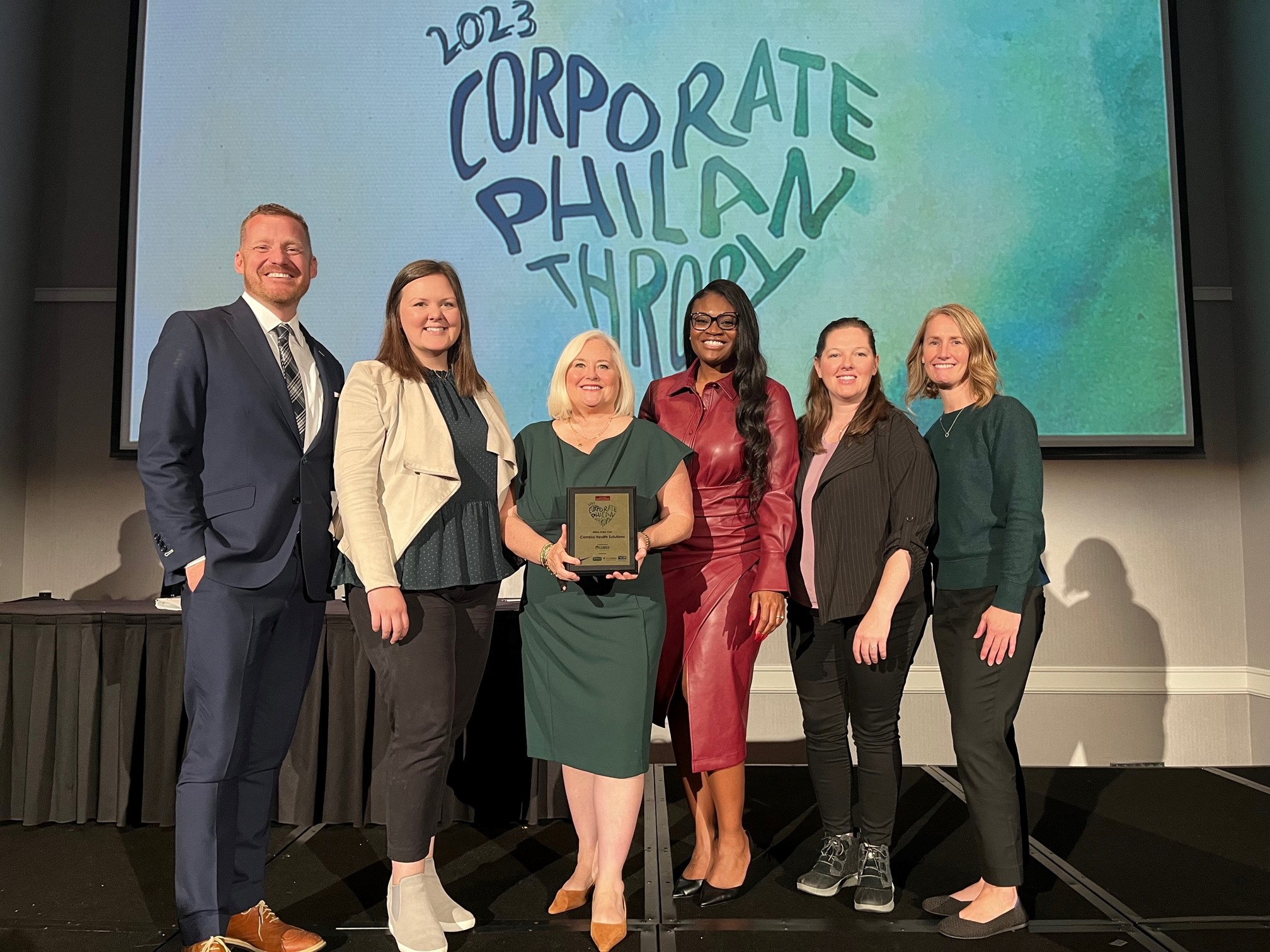 Group standing with award plaque