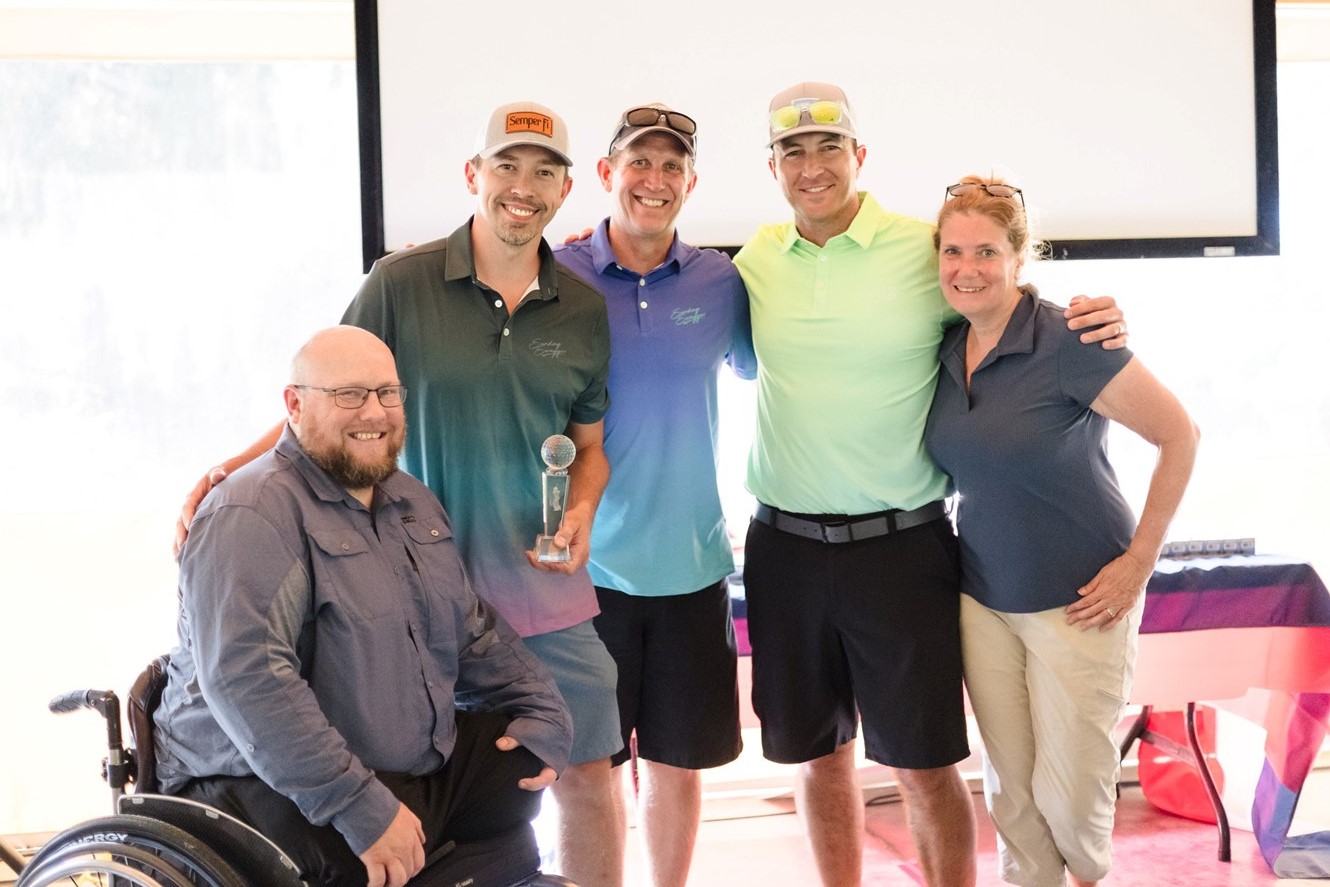 group of people posing with award