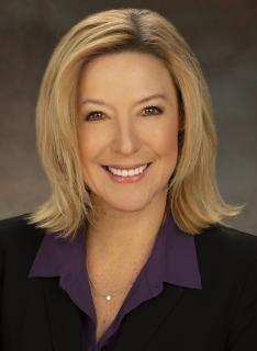 Dr. Donna Milavetz in a black blazer and purple shirt