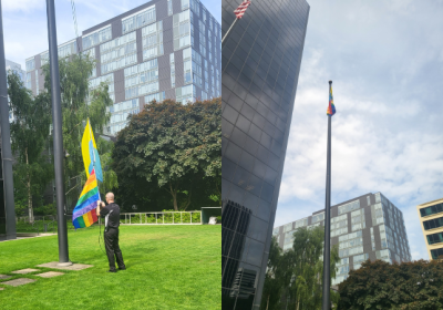 Pride flag flying in front of office building