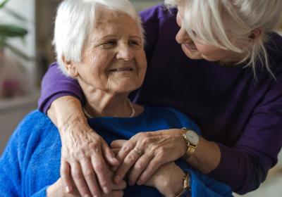 Two older women embracing
