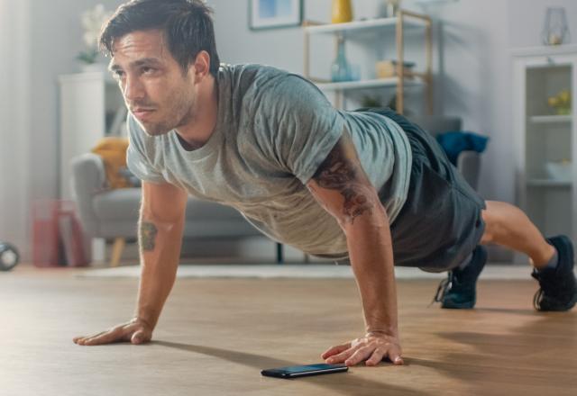 Man in his living room doing a push up