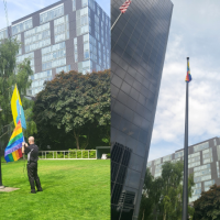 Pride flag flying in front of office building